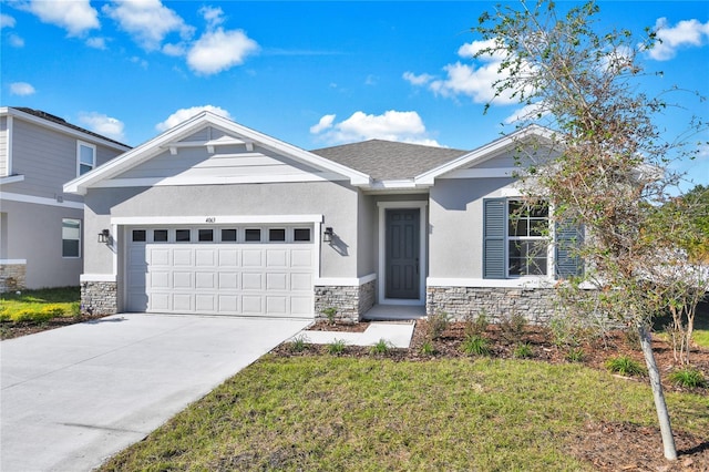 view of front of home featuring a front lawn and a garage