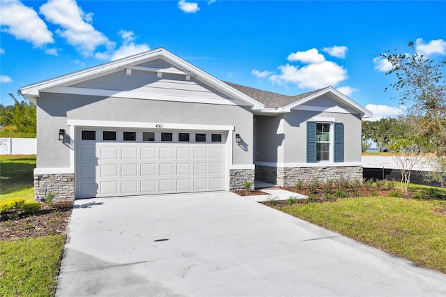 view of front of house featuring a garage and a front lawn