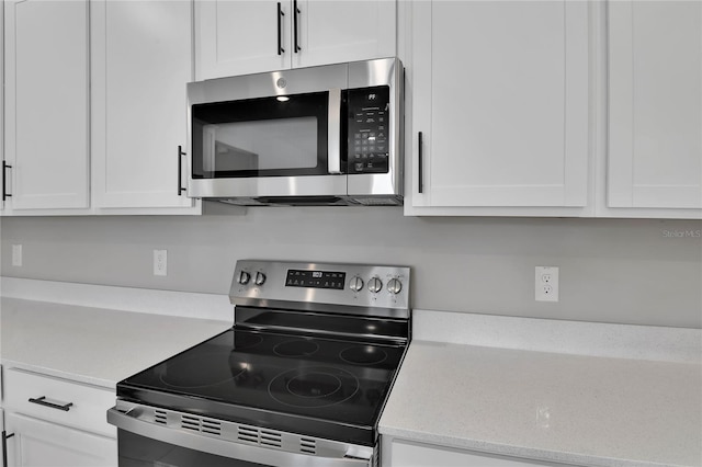 kitchen featuring white cabinetry and stainless steel appliances