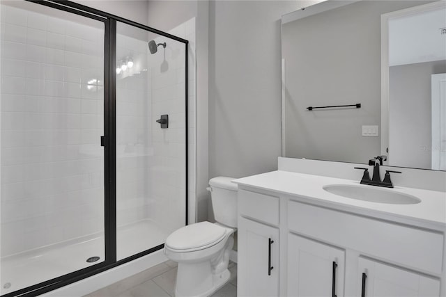 bathroom with an enclosed shower, vanity, tile patterned flooring, and toilet