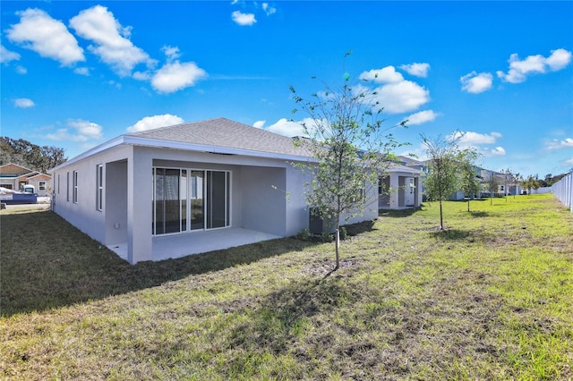 rear view of property featuring a yard