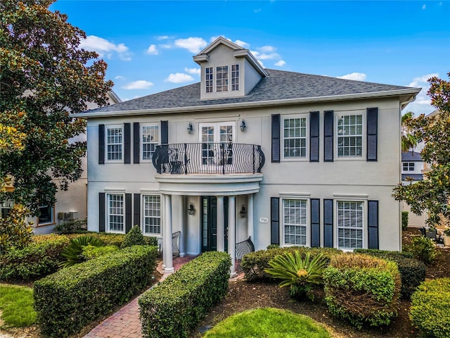 colonial inspired home with a balcony