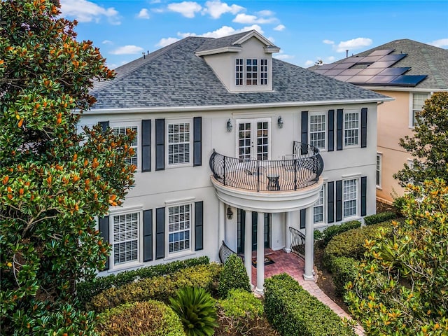 front facade featuring french doors and a balcony