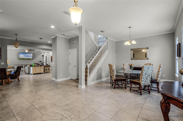 tiled dining area featuring a textured ceiling, ornamental molding, and a chandelier