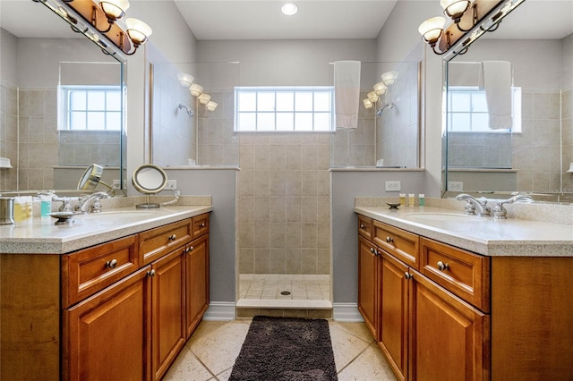 bathroom with vanity, a tile shower, and a chandelier