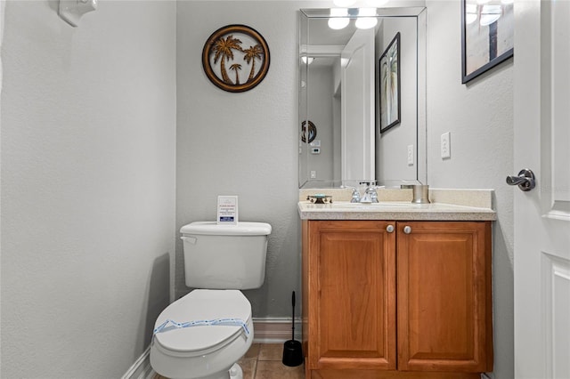 bathroom featuring vanity, toilet, and tile patterned flooring