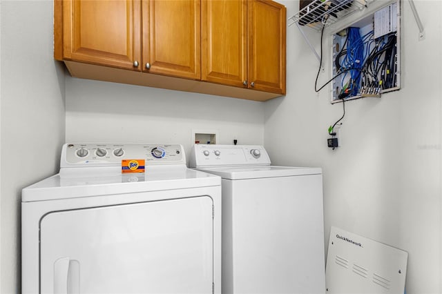 laundry area featuring cabinets and washer and clothes dryer