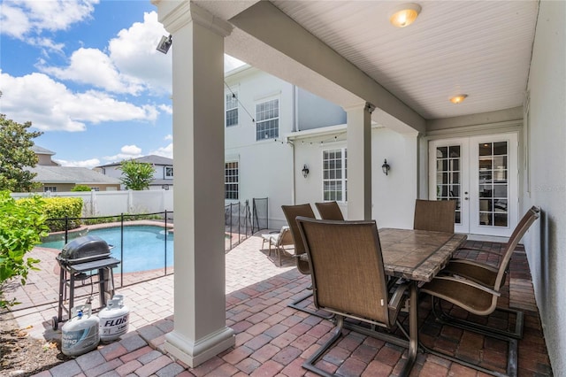 view of patio / terrace featuring a fenced in pool and french doors