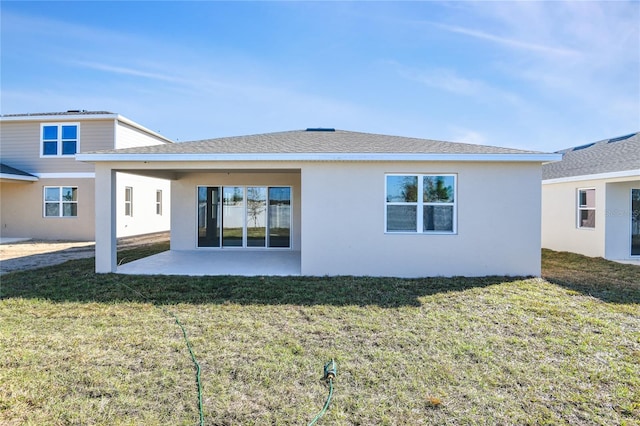 back of property featuring a lawn and a patio area