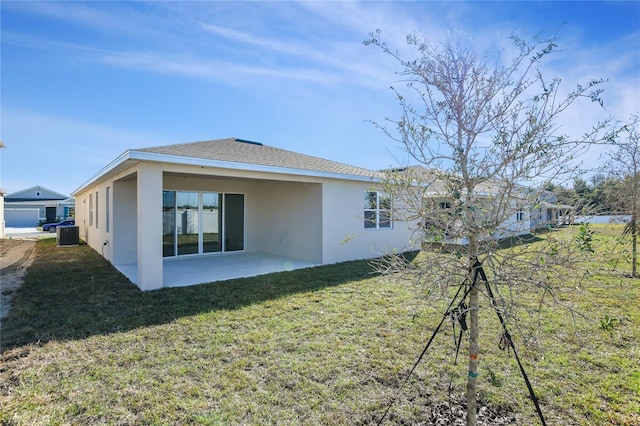 back of house featuring a patio area, a yard, and central AC