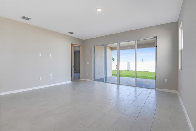 spare room featuring light tile patterned floors