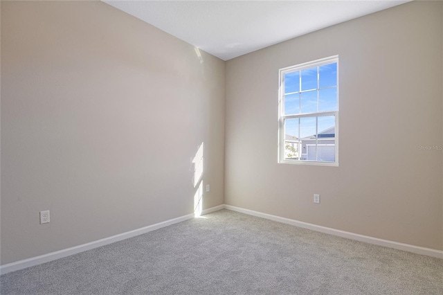 unfurnished room with light carpet