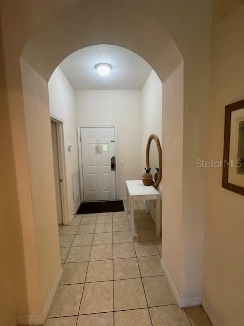 corridor featuring light tile patterned flooring