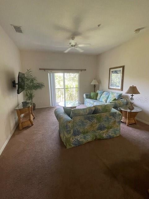 living room featuring ceiling fan and carpet flooring