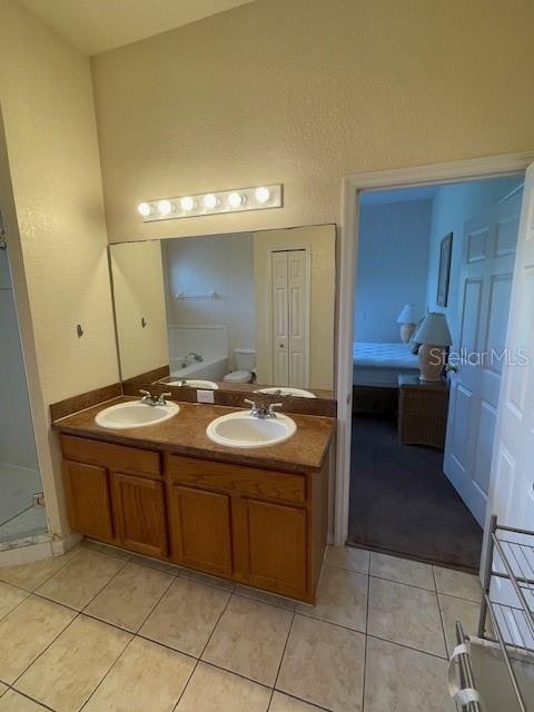 bathroom featuring tile patterned floors and double sink vanity