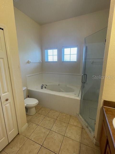 full bathroom with tile patterned flooring, independent shower and bath, toilet, and vanity