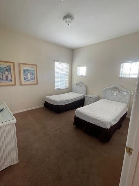 bedroom with dark colored carpet