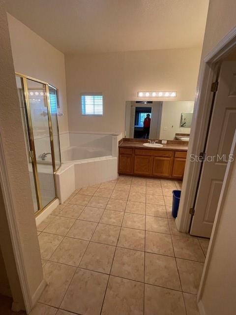 bathroom featuring independent shower and bath, tile patterned floors, and vanity