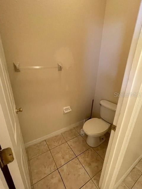 bathroom featuring tile patterned floors and toilet