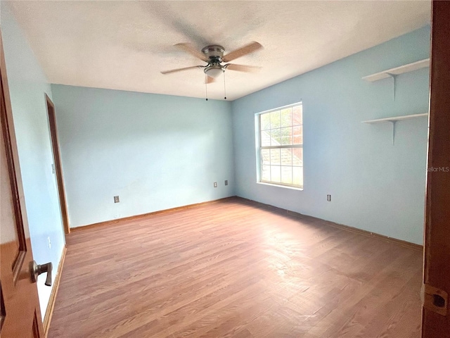 unfurnished room with ceiling fan and light hardwood / wood-style flooring