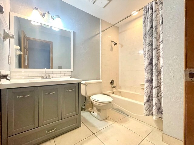 full bathroom featuring toilet, tile patterned floors, decorative backsplash, shower / bath combination with curtain, and vanity