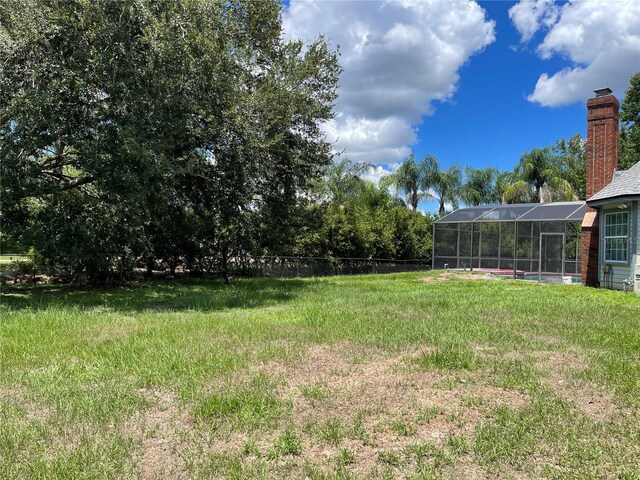 view of yard featuring glass enclosure