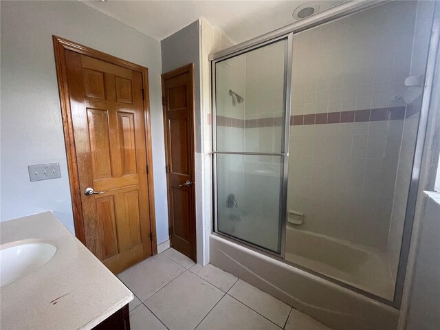 bathroom with shower / bath combination with glass door, tile patterned floors, and vanity