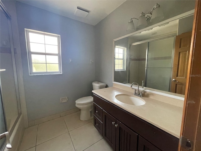 bathroom with toilet, a shower with door, vanity, and tile patterned floors