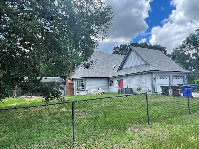 view of front of home featuring central air condition unit and a front lawn