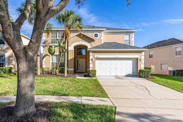 view of front of home featuring cooling unit, a garage, and a front lawn