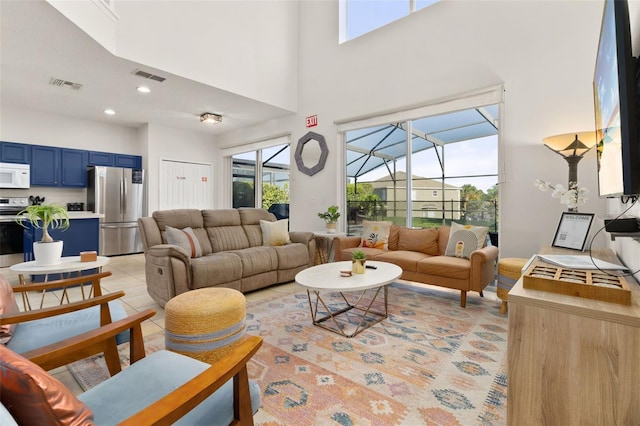 tiled living room with a towering ceiling