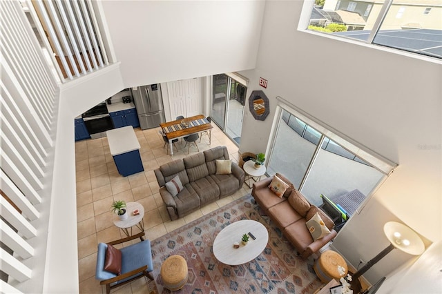 living room with tile patterned flooring and a high ceiling