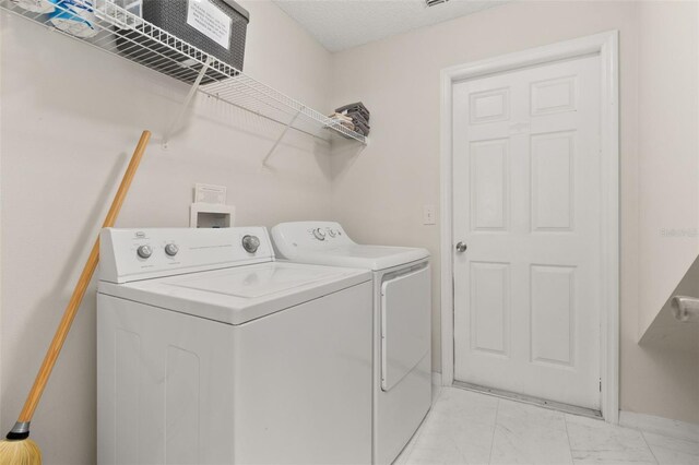 washroom with separate washer and dryer