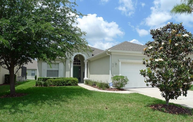 ranch-style home featuring a front yard and a garage