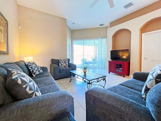 tiled living room with ceiling fan