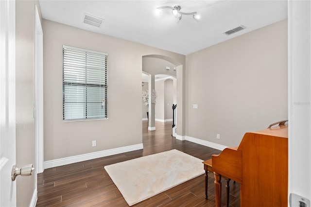 sitting room with dark wood-type flooring