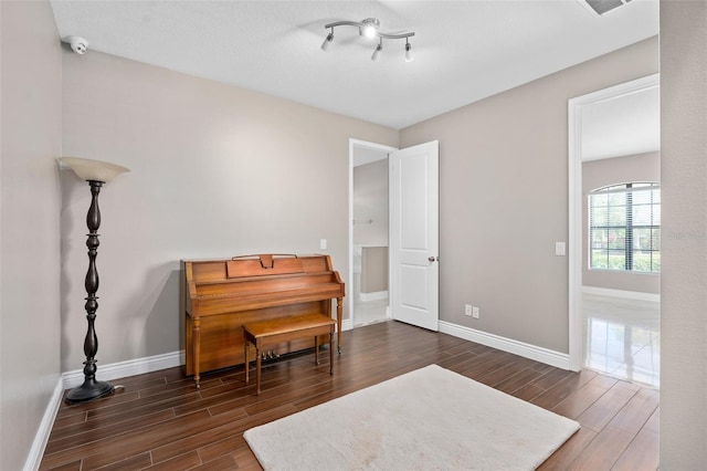 living area featuring baseboards and wood finished floors