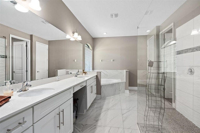 full bath with double vanity, marble finish floor, a bath, and a sink