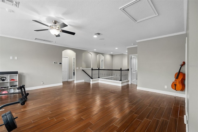 living room with ceiling fan, ornamental molding, and a textured ceiling