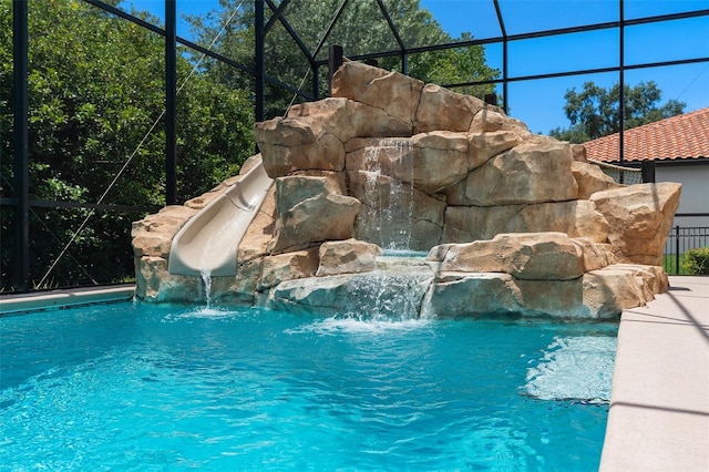 outdoor pool with a lanai and a water slide