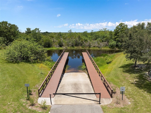 view of community with a water view and a yard