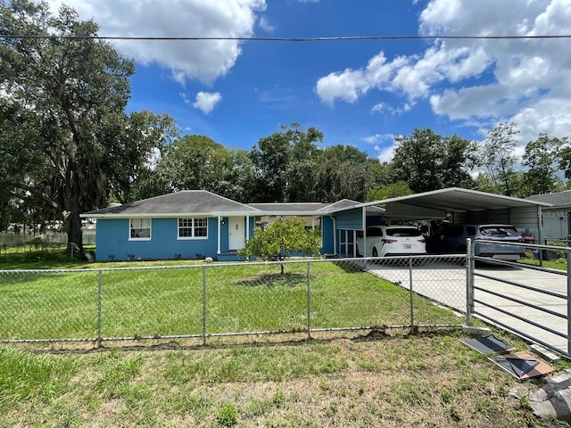 ranch-style house featuring a front lawn and a carport