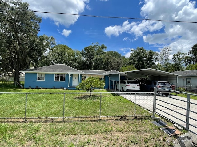 single story home featuring a carport and a front lawn