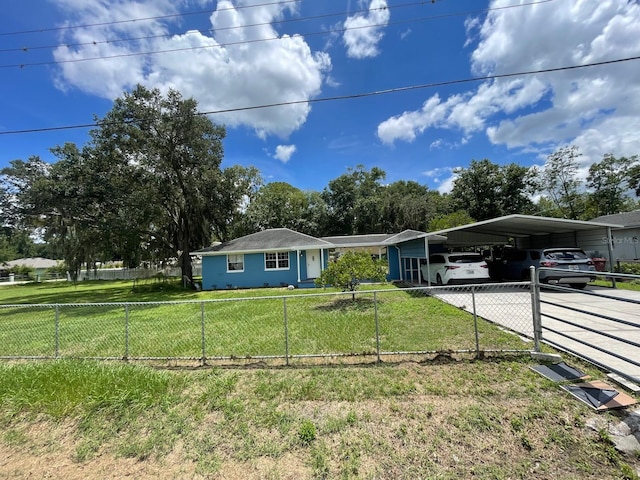 view of front of house with a front lawn and a carport