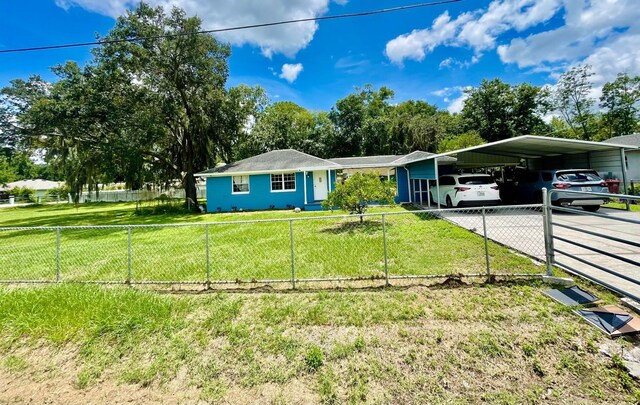 ranch-style home featuring a front lawn and a carport