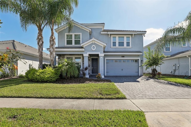 view of front of home featuring a front yard and a garage