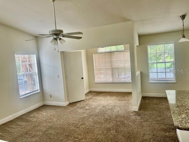 unfurnished bedroom featuring ceiling fan and carpet floors