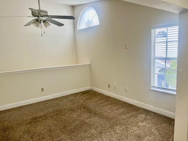 unfurnished room featuring lofted ceiling, ceiling fan, and carpet floors