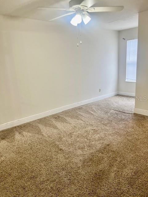 carpeted empty room featuring ceiling fan