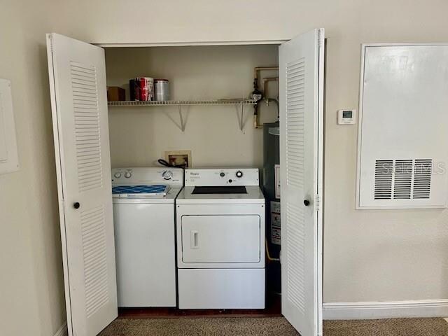 laundry area featuring dark colored carpet and independent washer and dryer